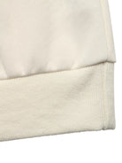 NEWYORKLISTED STYLE COLLECTION: Close-up of a beige fabric texture on a white background