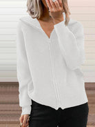 NEWYORKLISTED STYLE COLLECTION: White ribbed sweater worn by a person with a neutral background