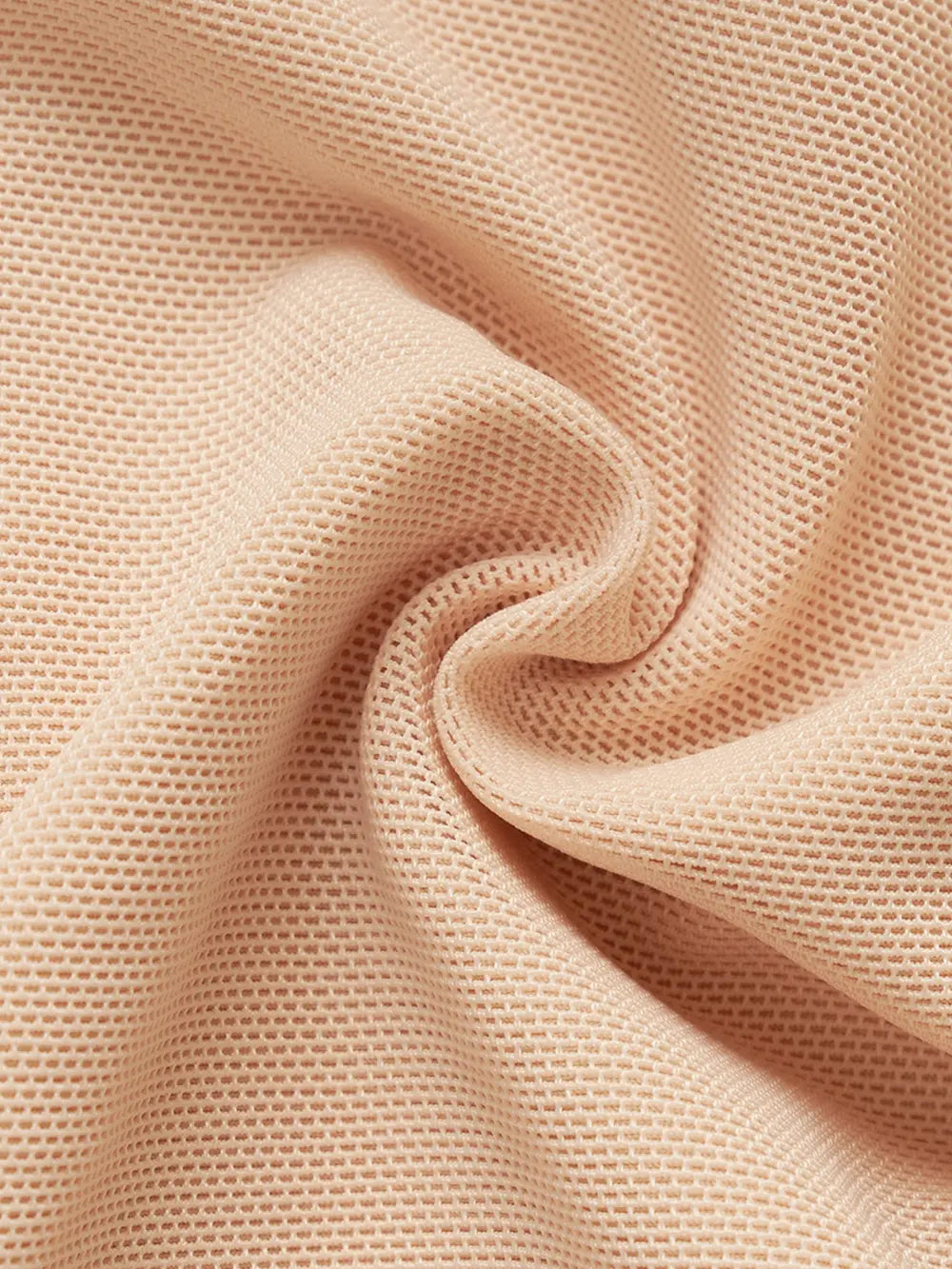 NEWYORKLISTED Intimate Apparel: Close-up of beige fabric with a textured pattern