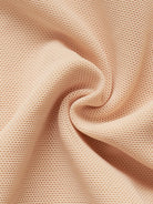 NEWYORKLISTED Intimate Apparel: Close-up of beige fabric with a textured pattern