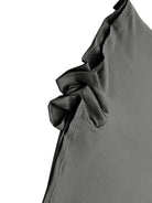 Close-up of a gray garment with a ruffled detail on a white background
