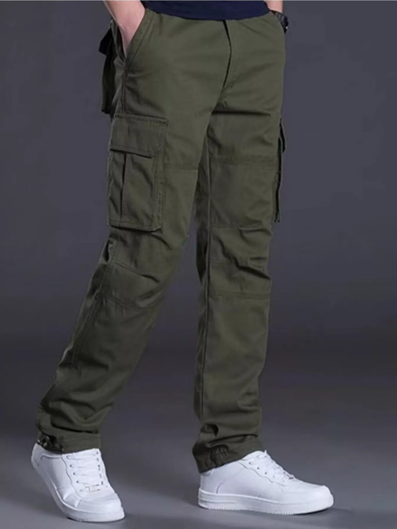 NEWYORKLISTED ATLAS MEN's COLLECTION: Person wearing olive green cargo pants with a plain background