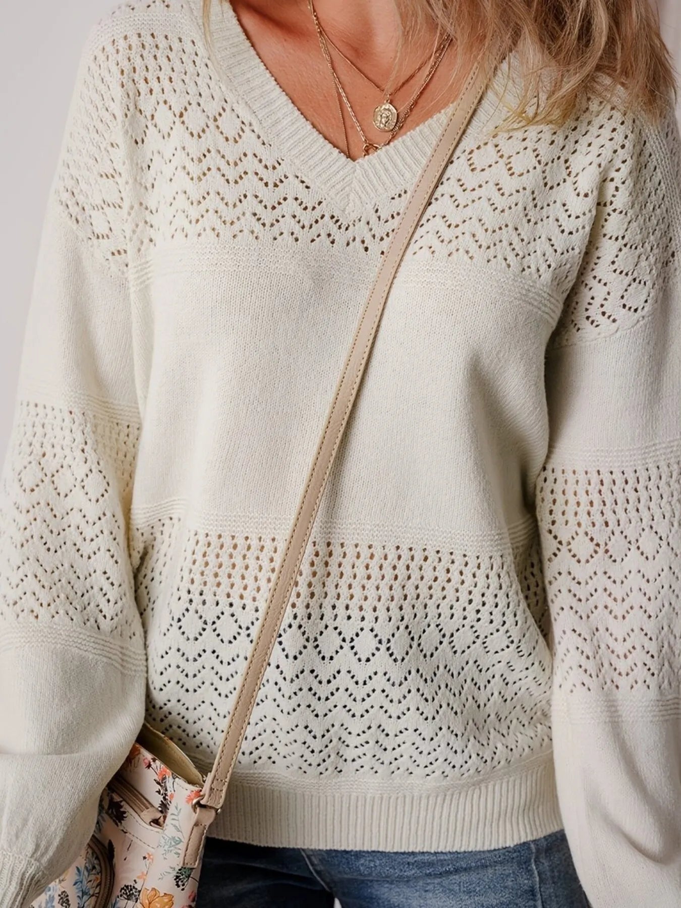 NEWYORKLISTED: Beige sweater with lace detailing worn by a person, with a neutral background