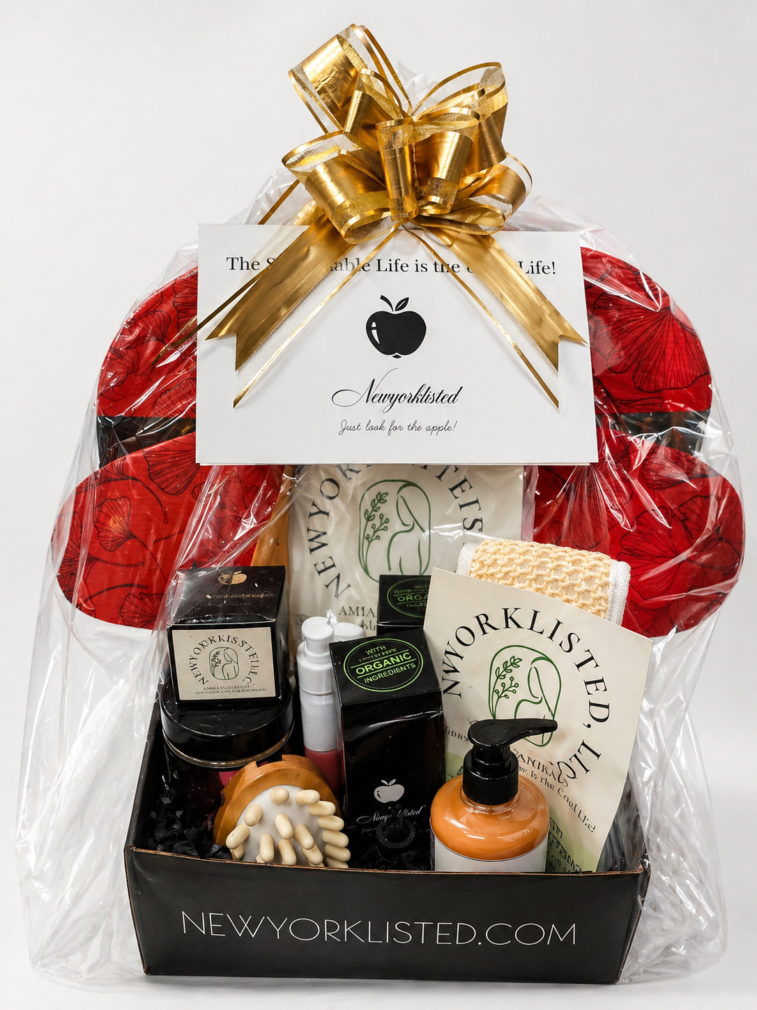 NEWYORKLISTED SPA EXPERIENCE LUXURY GIFT SET: Gift basket with various items including a gold bow, New York Listed branding, and a white card.