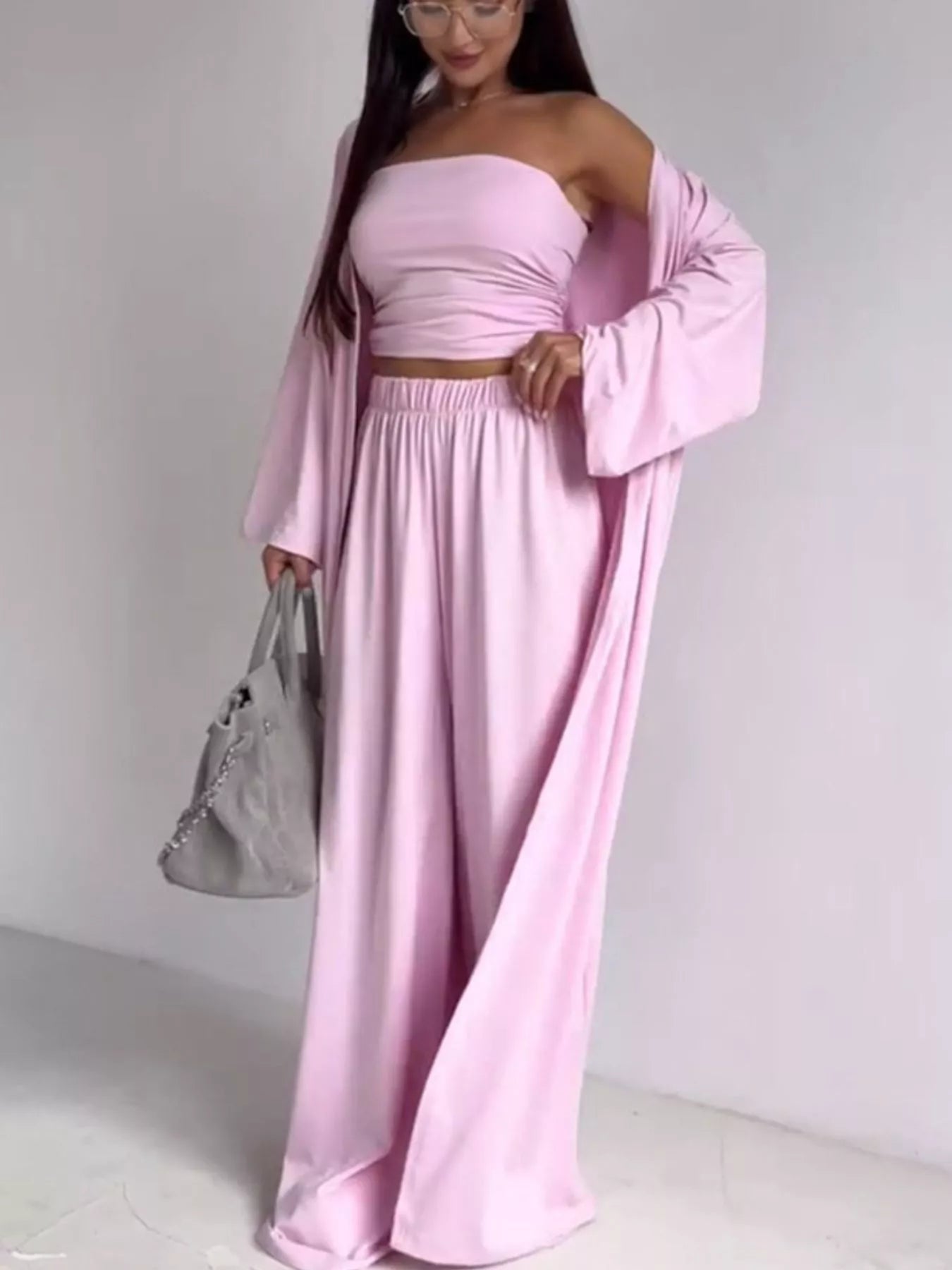 NEWYORKLISTED COMFORT COLLECTION: Woman wearing a pink dress with a matching jacket against a white background