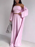 NEWYORKLISTED COMFORT COLLECTION: Woman wearing a pink dress with a matching jacket against a white background