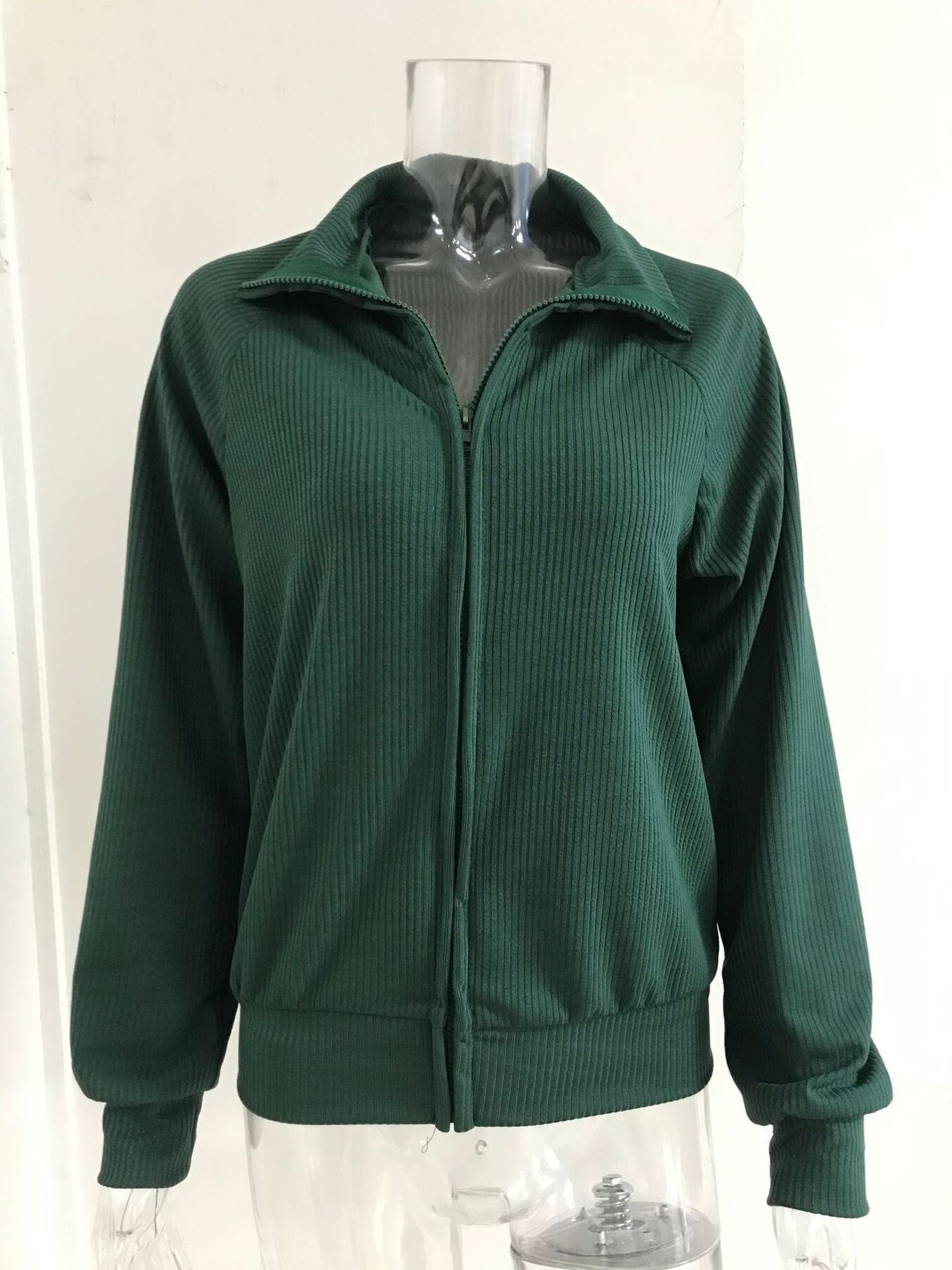 NEWYORKLISTED STYLE COLLECTION: Green jacket on a mannequin against a white background