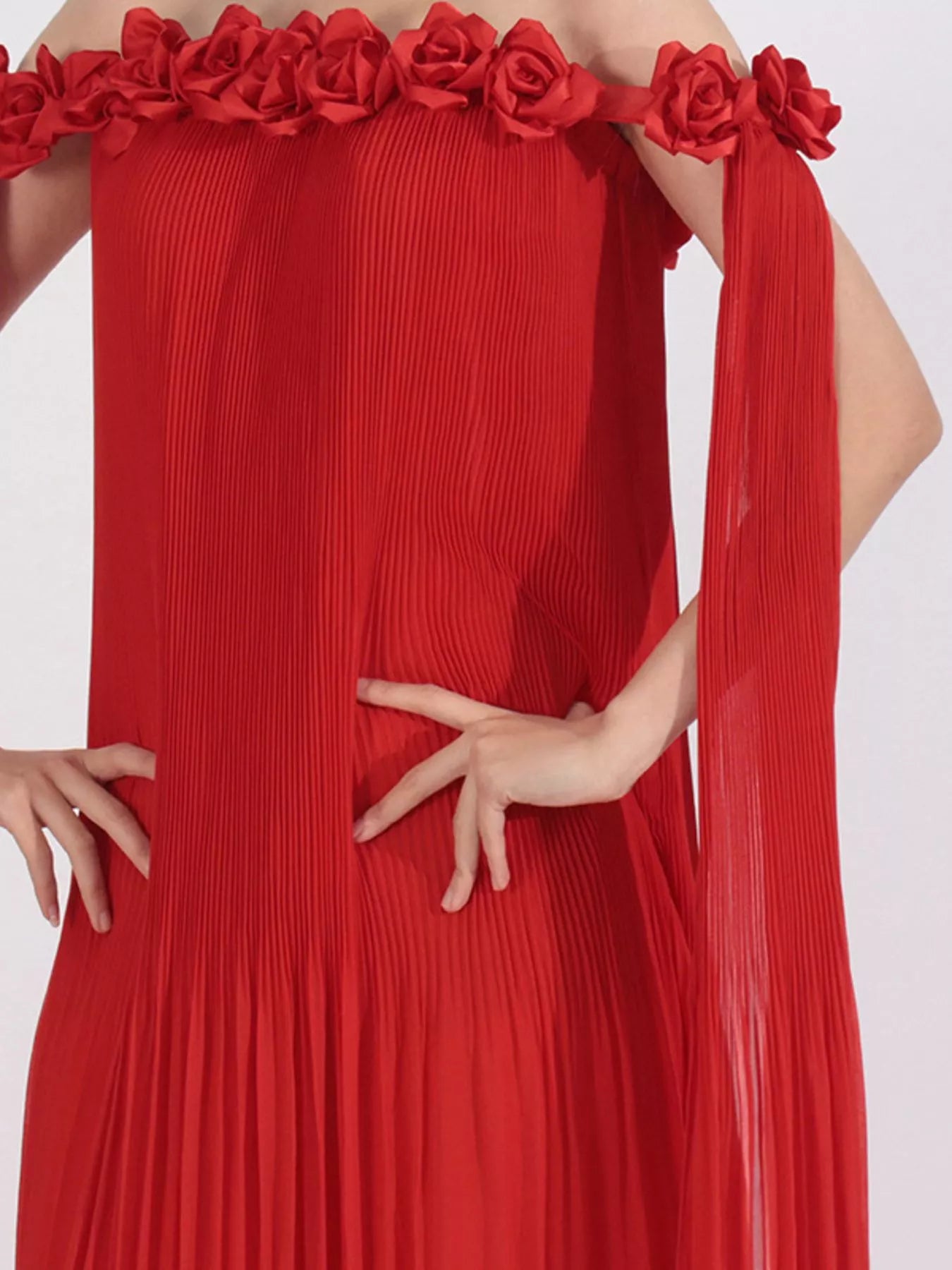 NEWYORKLISTED STYLE COLLECTION: Red off-shoulder dress with floral details on a white background