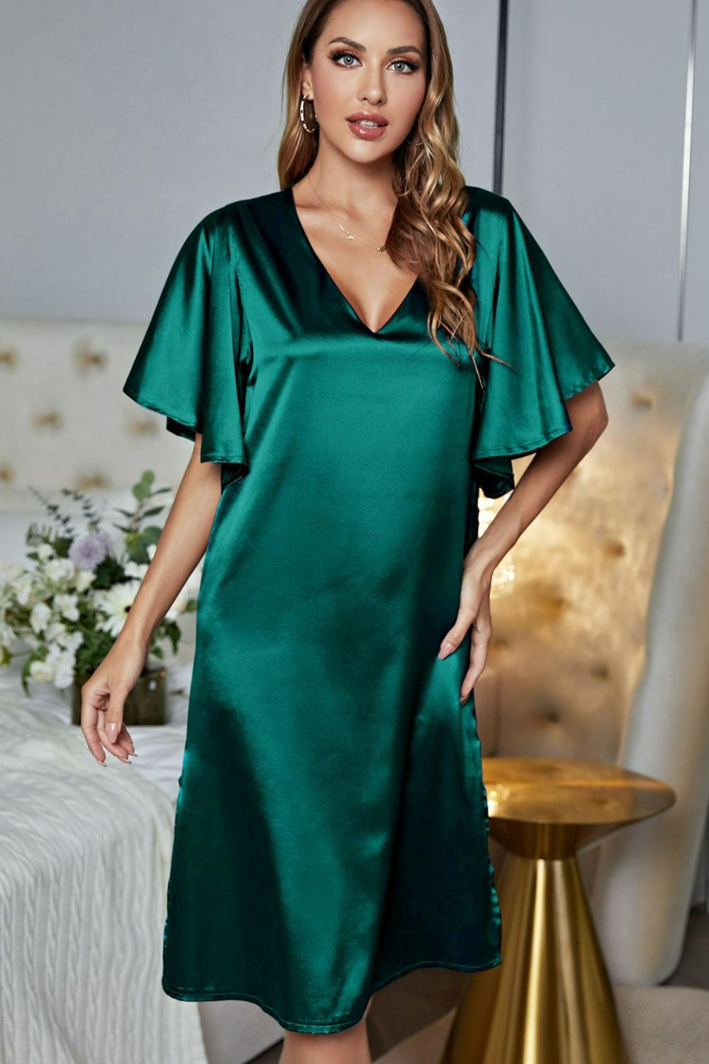 NEWYORKLISTED Intimate Apparel: Woman wearing a green satin dress in a bedroom setting