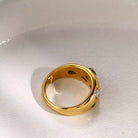 NYLD Glamour Collection by NEWYORKLISTED: Gold ring with gemstones on a white background