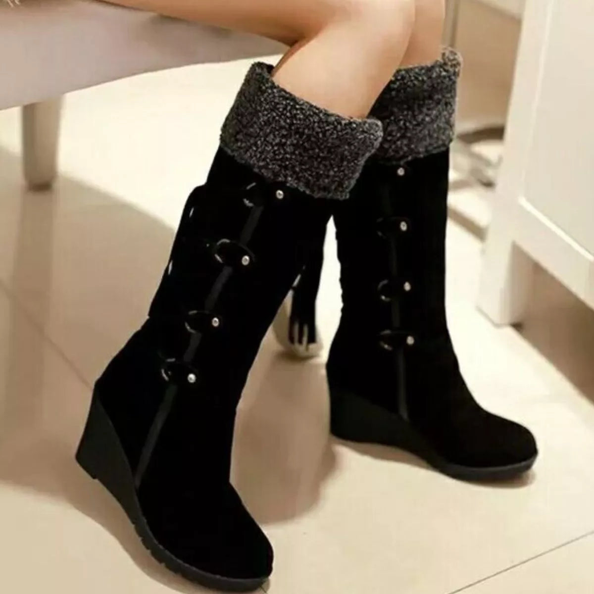 NEWYORKLISTED SHOE COLLECTION: Black knee-high boots with textured cuffs on a light background