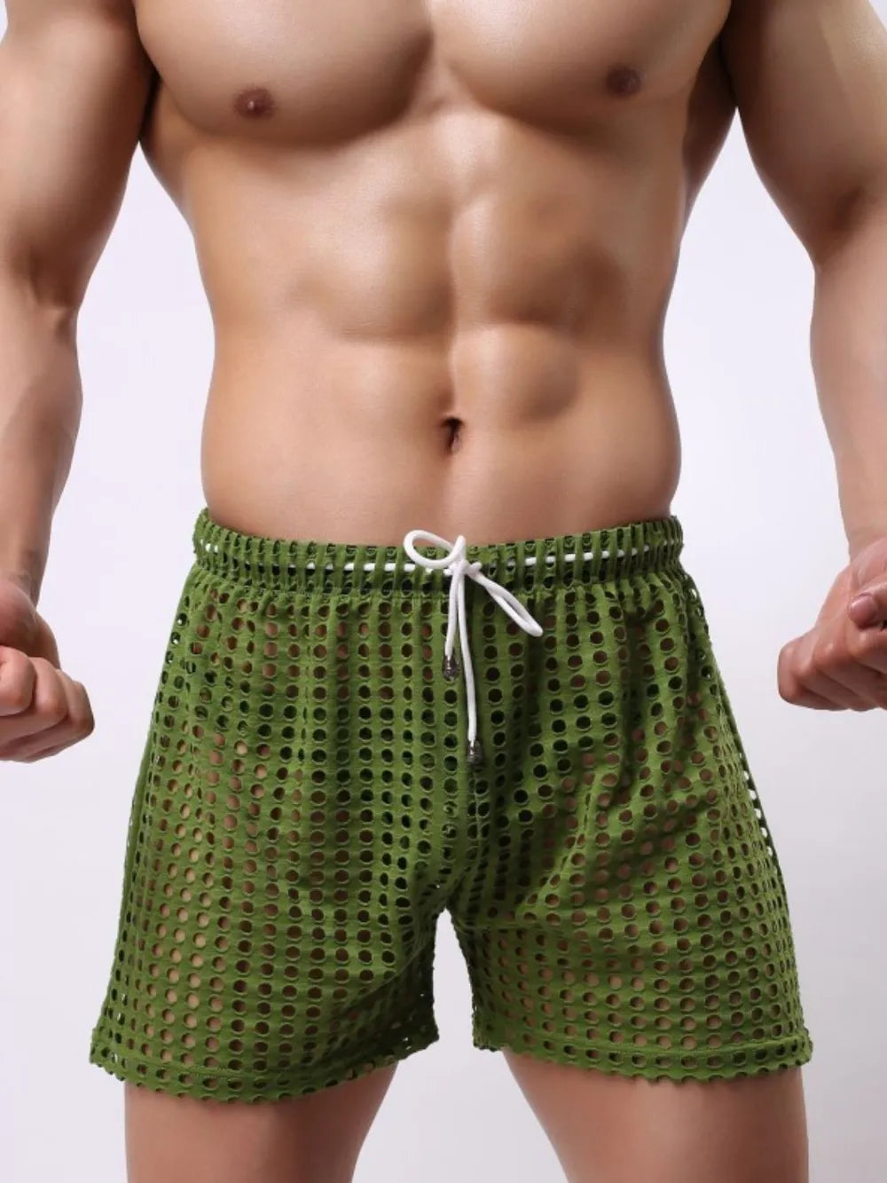 NEWYORKLISTED ATLAS MEN'S COLLECTION: Green swim shorts worn by a person on a plain background
