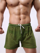 NEWYORKLISTED ATLAS MEN'S COLLECTION: Green swim shorts worn by a person on a plain background