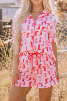 NEWYORKLISTED Intimate Apparel: Woman wearing a pink and red patterned romper with a blurred outdoor background