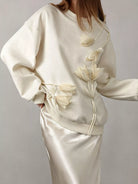 NEWYORKLISTED STYLE COLLECTION: White outfit with floral details on a plain background