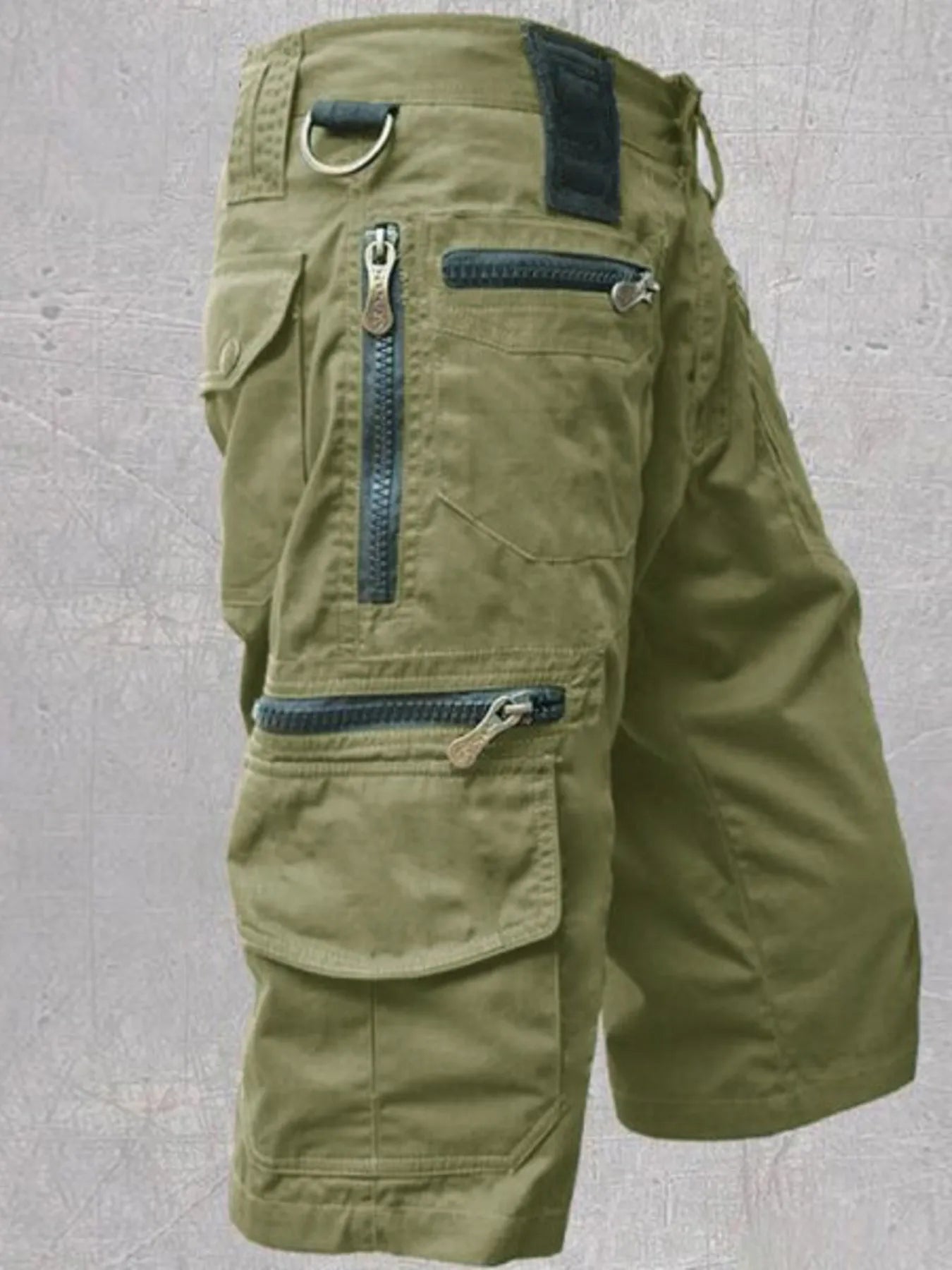 NEWYORKLISTED ATLAS MEN'S COLLECTION: Green cargo shorts with multiple pockets and zippers on a gray background