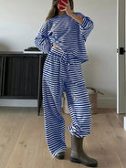 NEWYORKLISTED Comfort Collection: Person wearing a blue and white striped outfit with gray boots indoors.