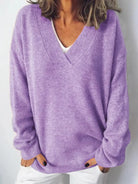NEWYORKLISTED STYLE COLLECTION: Person wearing a purple sweater against a white background