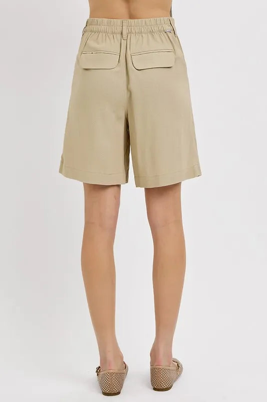 NEWYORKLISTED STYLE COLLECTION: Beige shorts worn by a person on a white background
