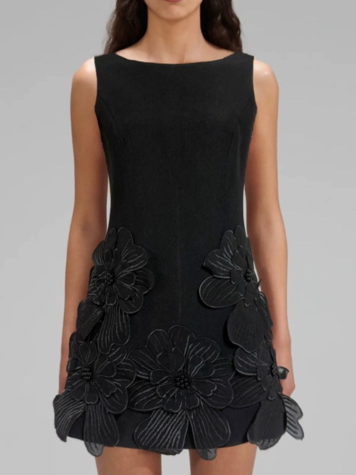NEWYORKLISTED STYLE COLLECTION: Black dress with floral embellishments on a gray background