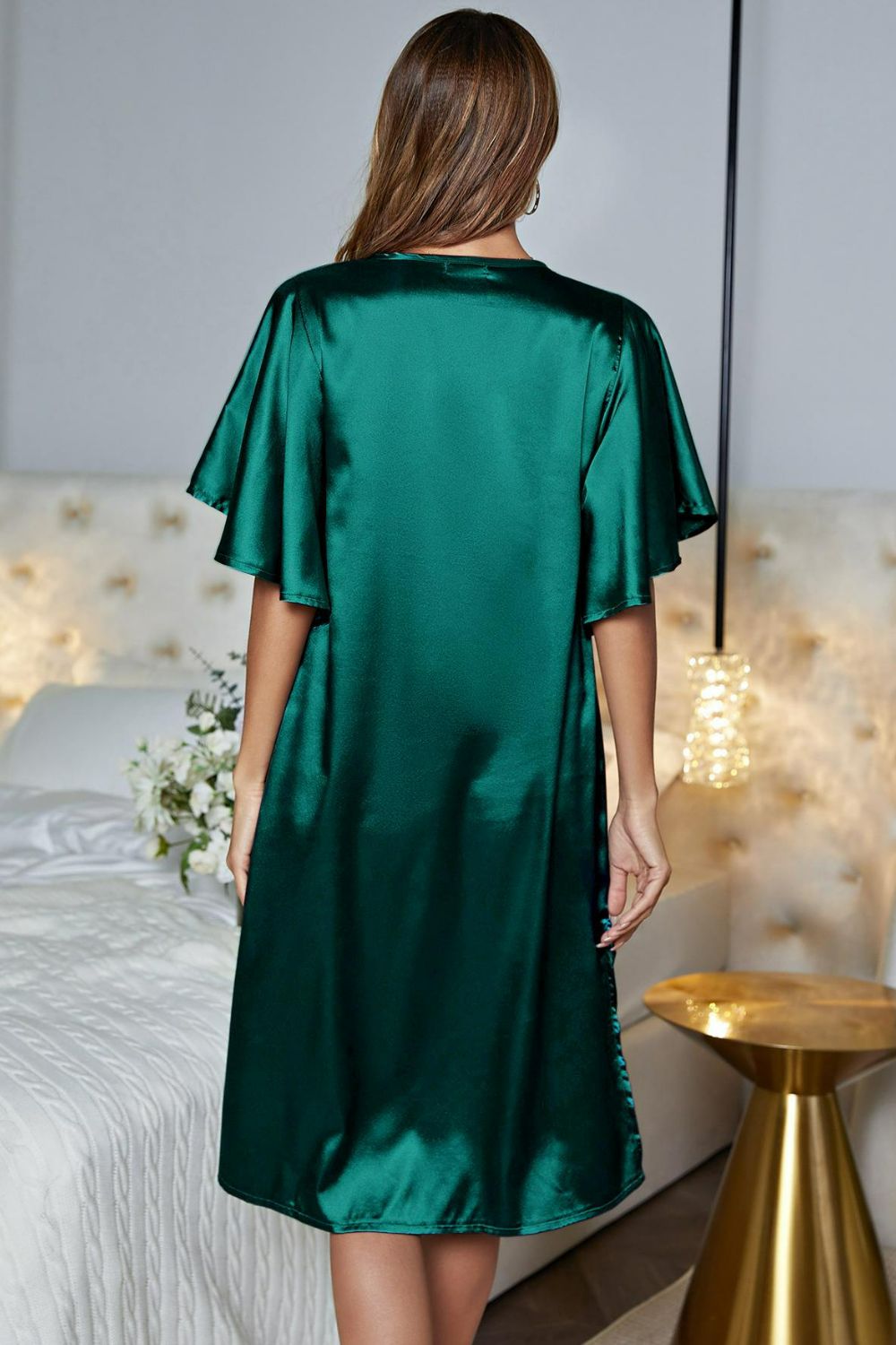 NEWYORKLISTED Intimate Apparel: Woman wearing a green satin robe in a bedroom setting