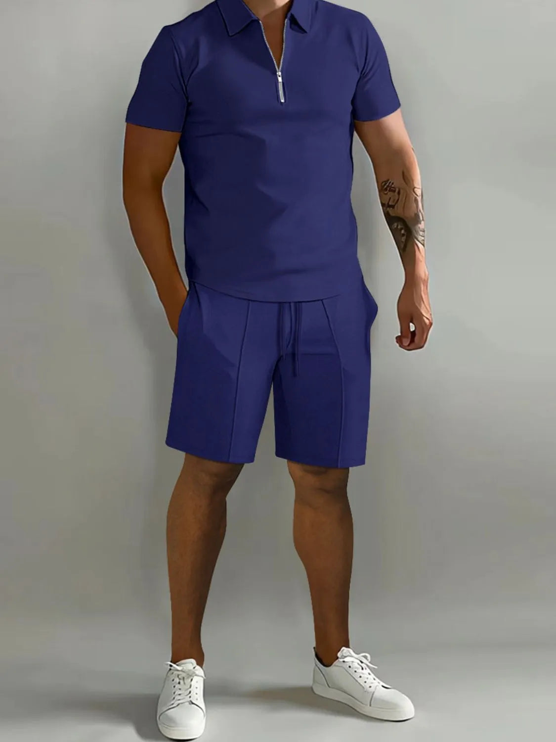 NEWYORKLISTED ATLAS MEN's COLLECTION: Person wearing a blue outfit with a polo shirt and shorts on a gray background