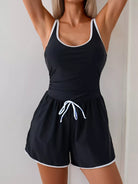 NEWYORKLISTED STYLE COLLECTION: Black tank top and shorts set with white trim on a plain background