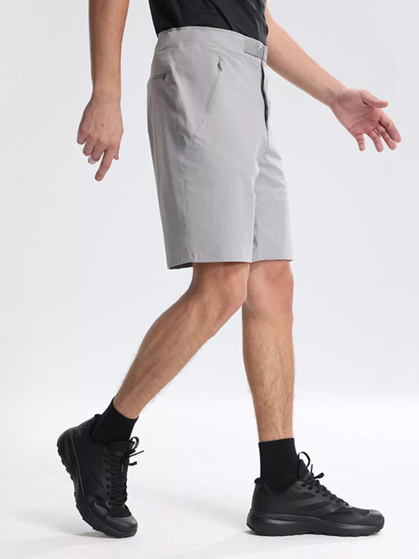 NEWYORKLISTED ATLAS MEN's COLLECTION: Person wearing gray shorts and black shoes on a white background
