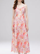 NEWYORKLISTED STYLE COLLECTION: Woman wearing a floral dress on a plain background