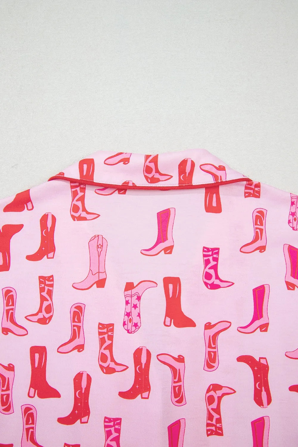 NEWYORKLISTED Intimate Apparel: Pink fabric with red boot pattern on a white background