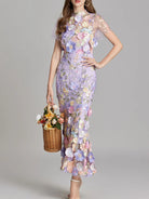 NEWYORKLSTE STYLE COLLECTION: Woman wearing a floral dress with a gray background