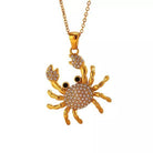 NYLD Glamour Collection by NEWYORKLISTED: Gold crab-shaped pendant necklace on a white background