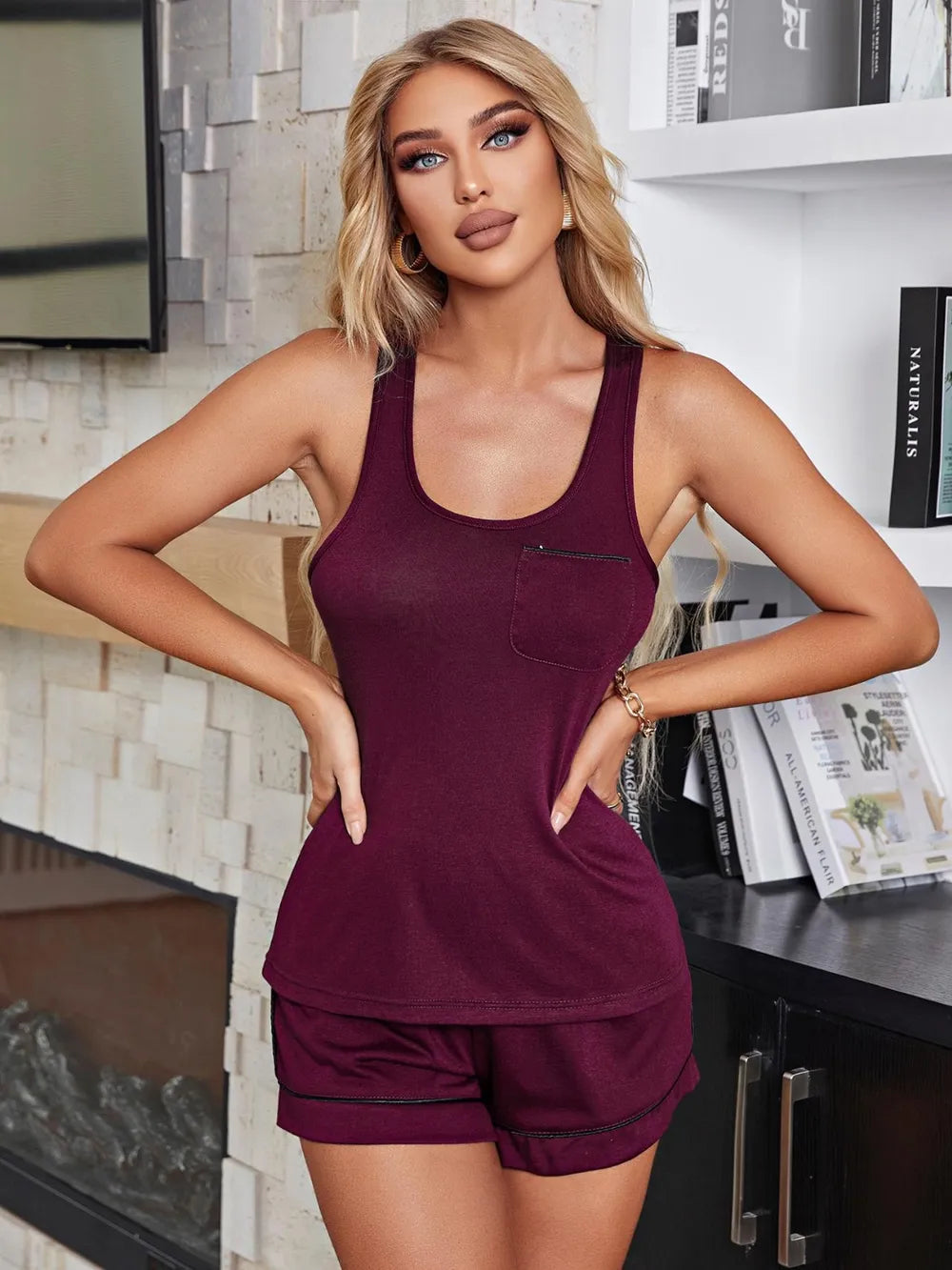 NEWYORKLISTED Intimate Apparel Collection: Woman wearing a maroon tank top and shorts in a modern kitchen.