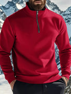 NEWYORKLISTED ATLAS MEN'S COLLECTION: Person wearing a red pullover with a mountainous background