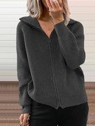 NEWYORKLISTED STYLE COLLECTION: Person wearing a gray ribbed zip-up hoodie against a neutral background