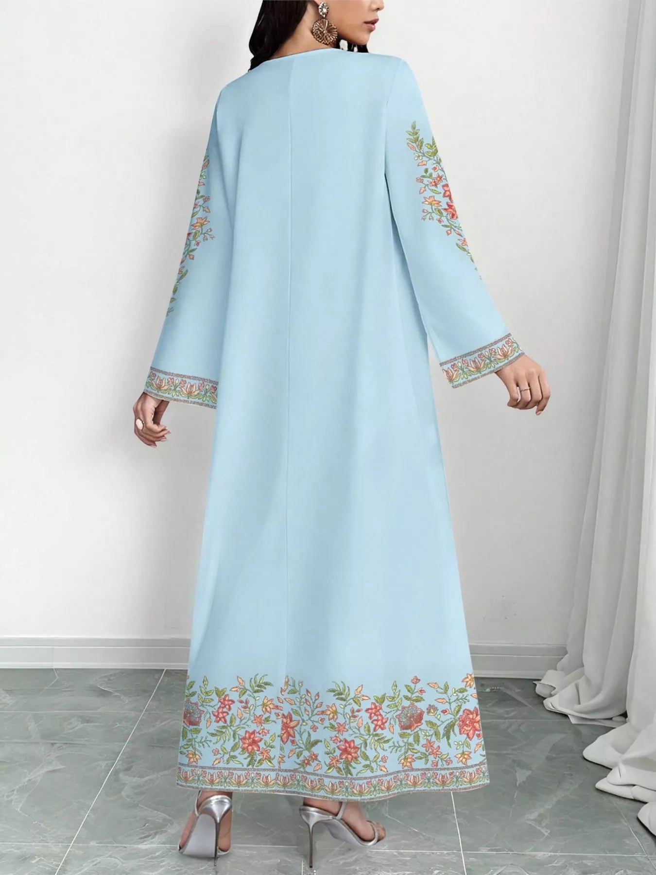 NEWYORKLISTED STYLE COLLECTION: Light blue dress with floral embroidery on a white background