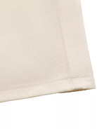 NEWYORKLISTED STYLE COLLECTION: Close-up of beige fabric with a subtle texture on a white background