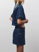 NEWYORKLISTED STYLE COLLECTION: Person wearing a dark blue denim outfit on a plain background