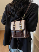 NEWYORKLISTED STYLE COLLECTION: Person wearing a two-tone backpack with beige and brown design.