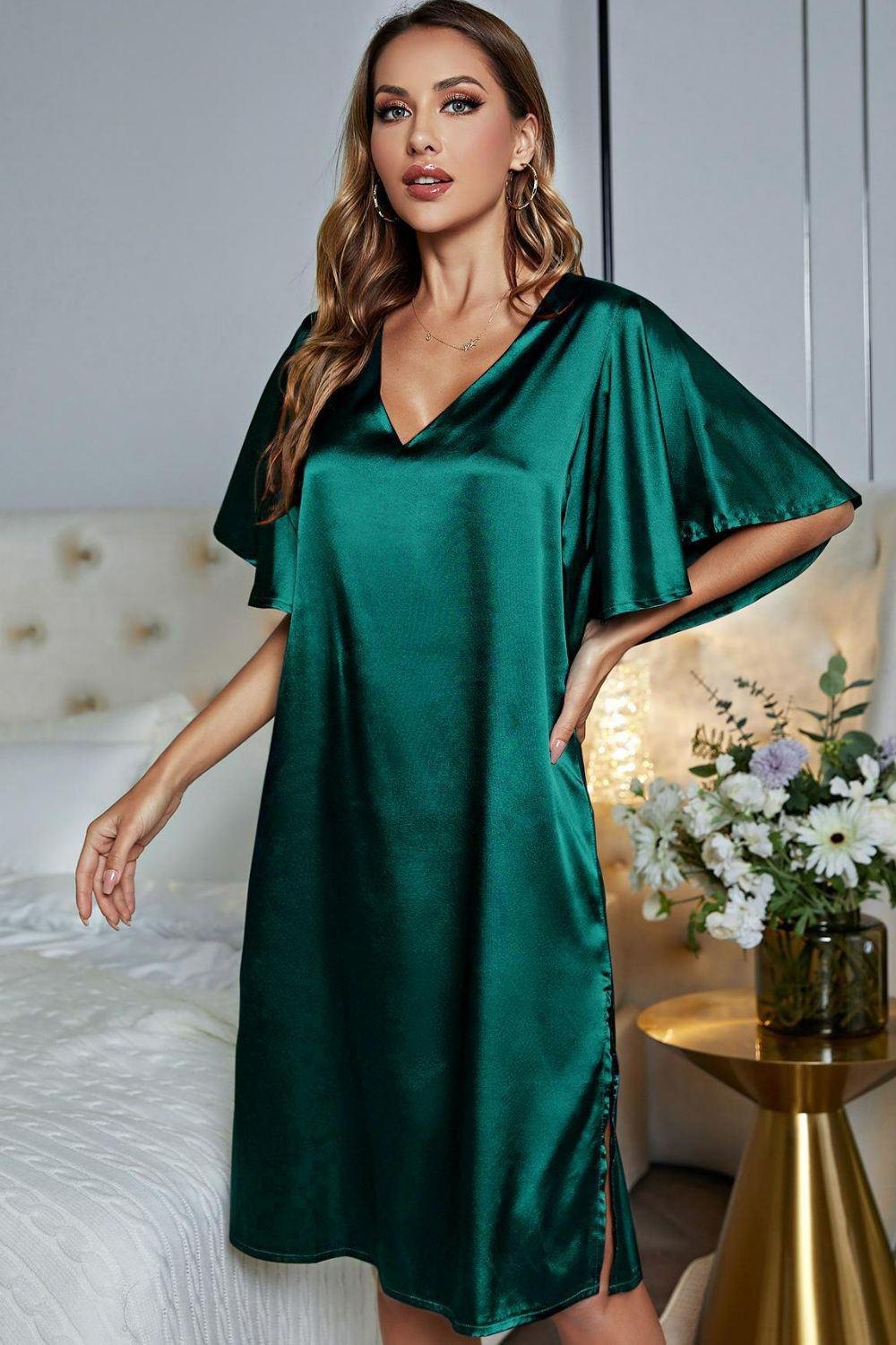 NEWYORKLISTED Intimate Apparel: Woman wearing a green satin nightgown in a bedroom setting.