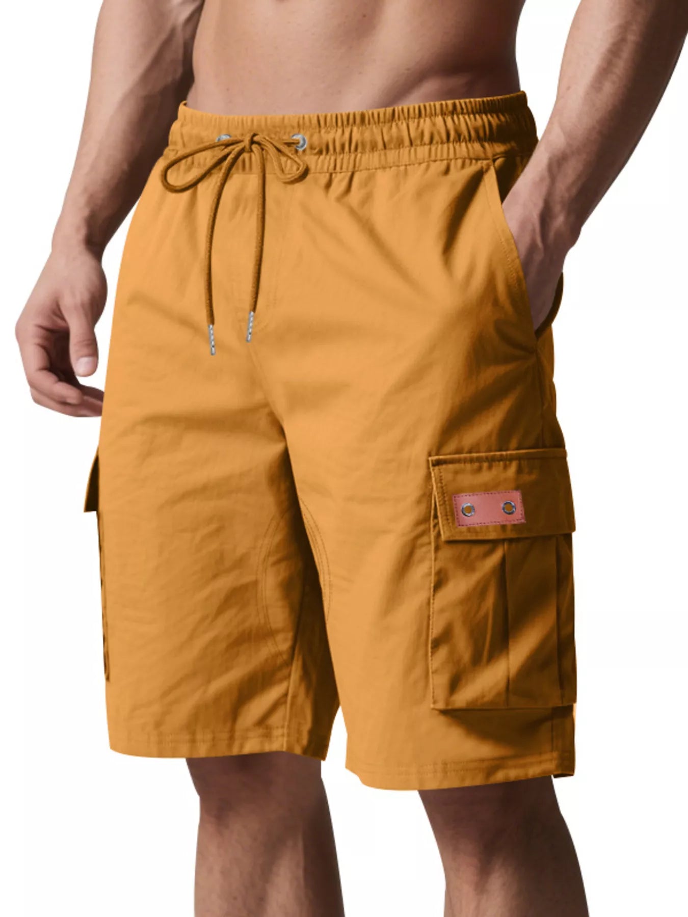 NEWYORKLISTED ATLAS MEN'S COLLECTION: Mustard yellow cargo shorts worn by a person on a white background