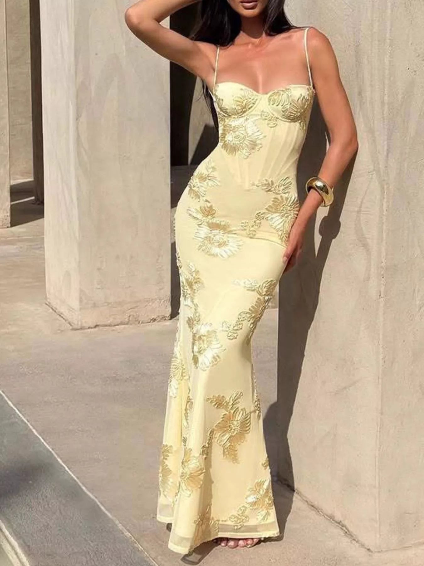 NEWYORKLISTED STYLE COLLECTION: Woman wearing a yellow lace evening gown against a neutral background
