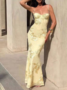 NEWYORKLISTED STYLE COLLECTION: Woman wearing a yellow lace evening gown against a neutral background