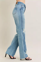 NEWYORKLISTED STYLE COLLECTION: Light blue jeans with a slight distressed look worn by a person on a beige background