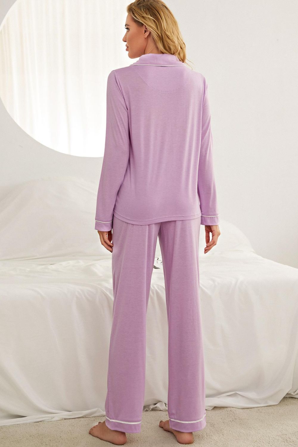 NEWYORKLISTED Intimate Apparel: Woman wearing a lavender pajama set against a white background