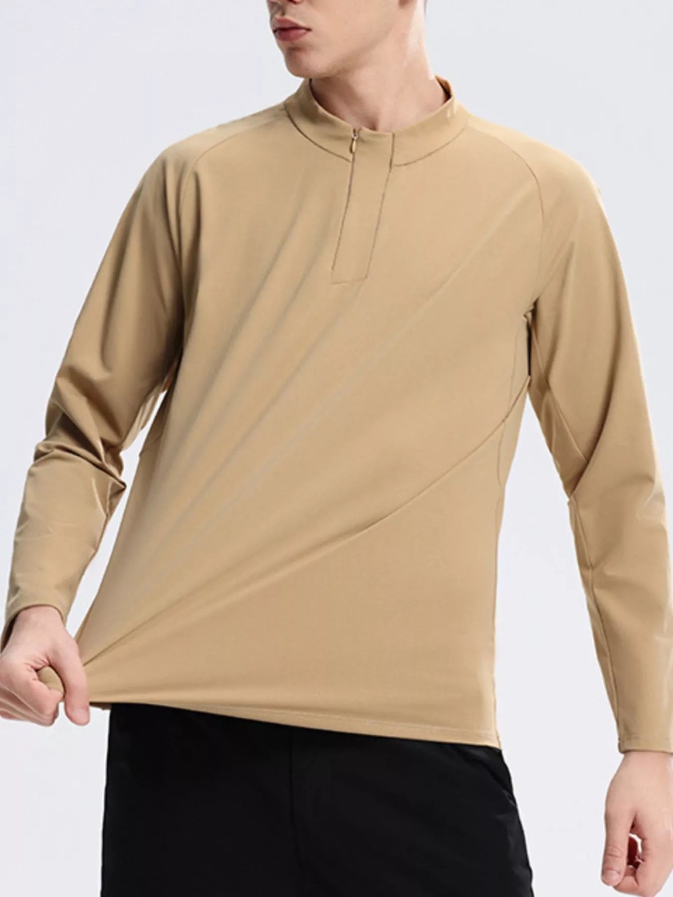 NEWYORKLISTED ATLAS MEN's COLLECTION: Man wearing a beige long-sleeve shirt on a light gray background