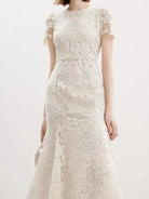 NEWYORKLISTED STYLE COLLECTION: White lace dress on a white background