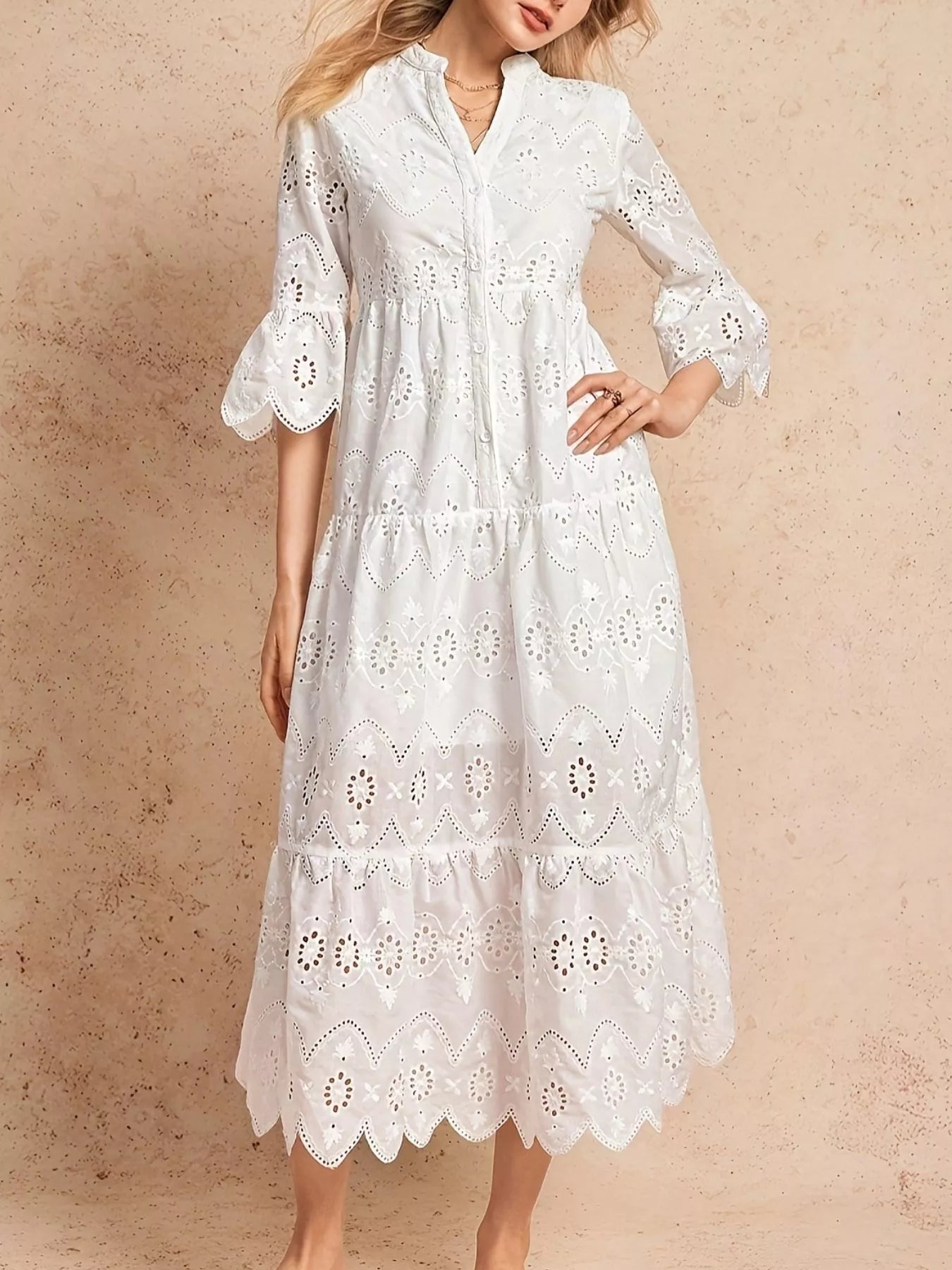 NEWYORKLISTED STYLE COLLECTION: White lace dress worn by a model on a beige background