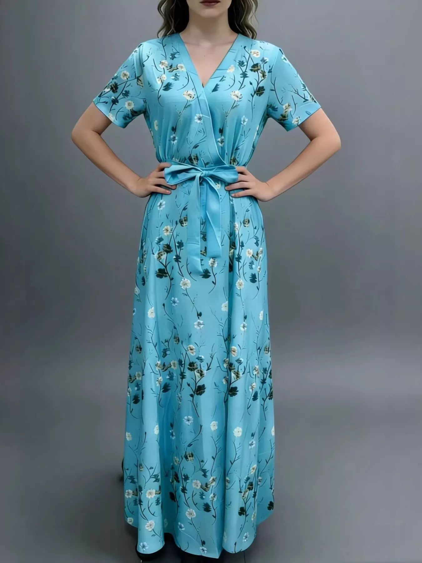 NEWYORKLISTED STYLE COLLECTION: Woman wearing a blue floral dress against a gray background