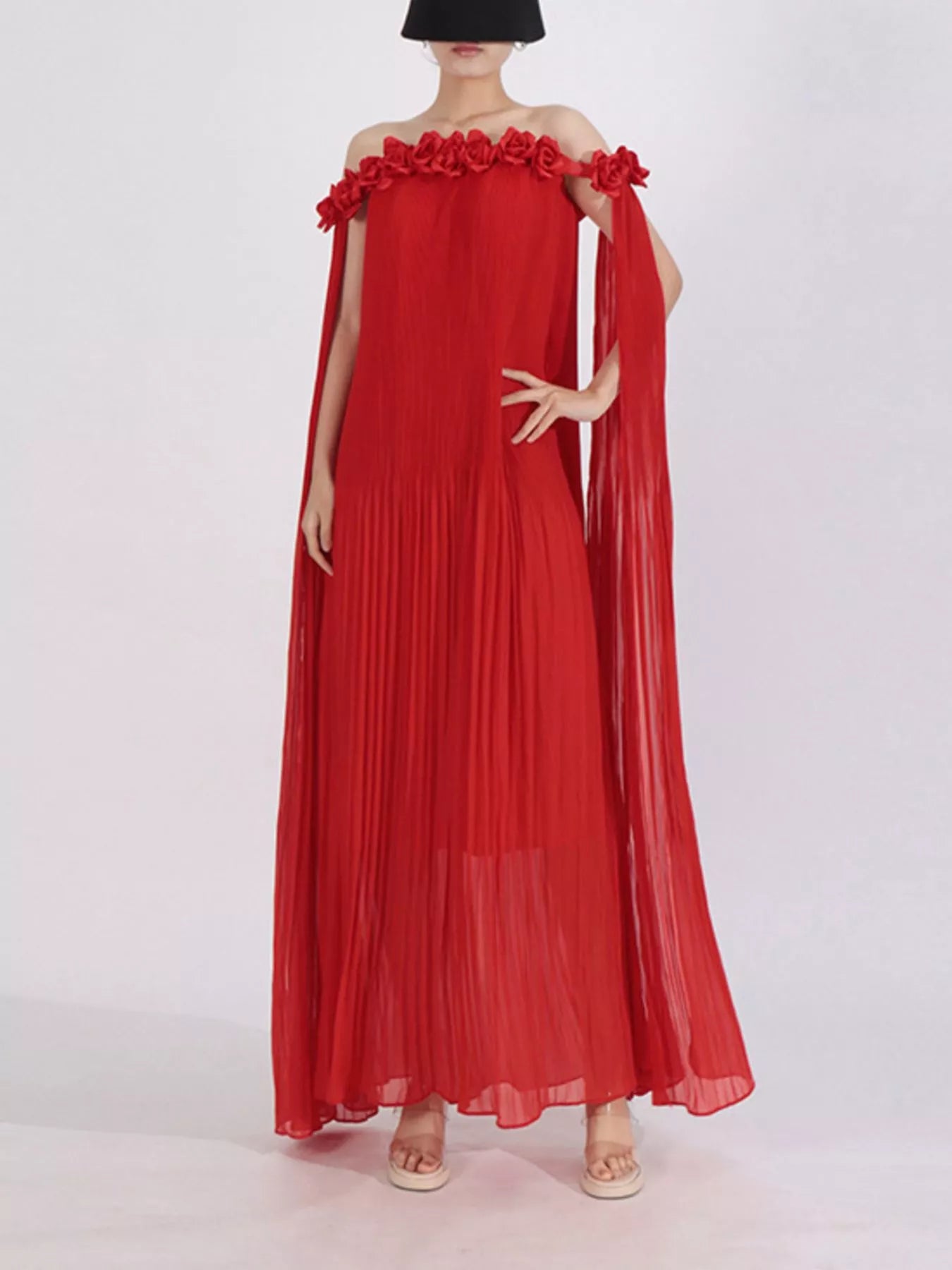 NEWYORKLISTED STYLE COLLECTION: Woman wearing a long, off-shoulder red dress with floral details 